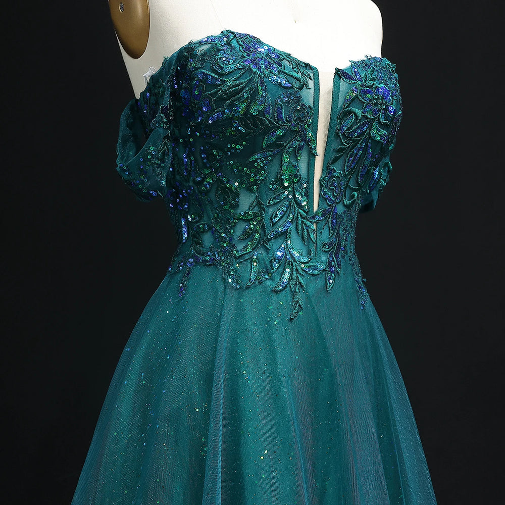 Teal evening gown with intricate beadwork on a black background