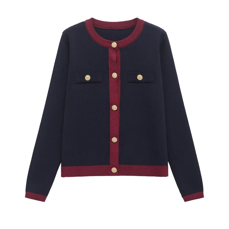 Navy blue cardigan with red trim and gold buttons on a white background