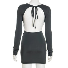 Black dress with sheer back panel on a mannequin against a white background