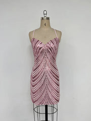 Pink sequin dress on a mannequin against a white background