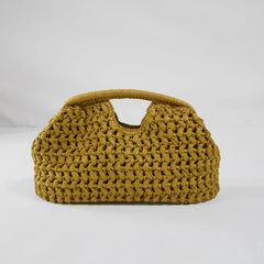 Brown woven straw handbag with top handle on light backdrop