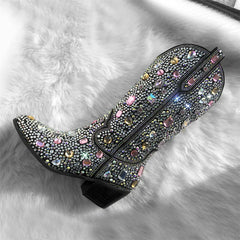 Decorative boot with colorful gemstones on a fluffy white surface