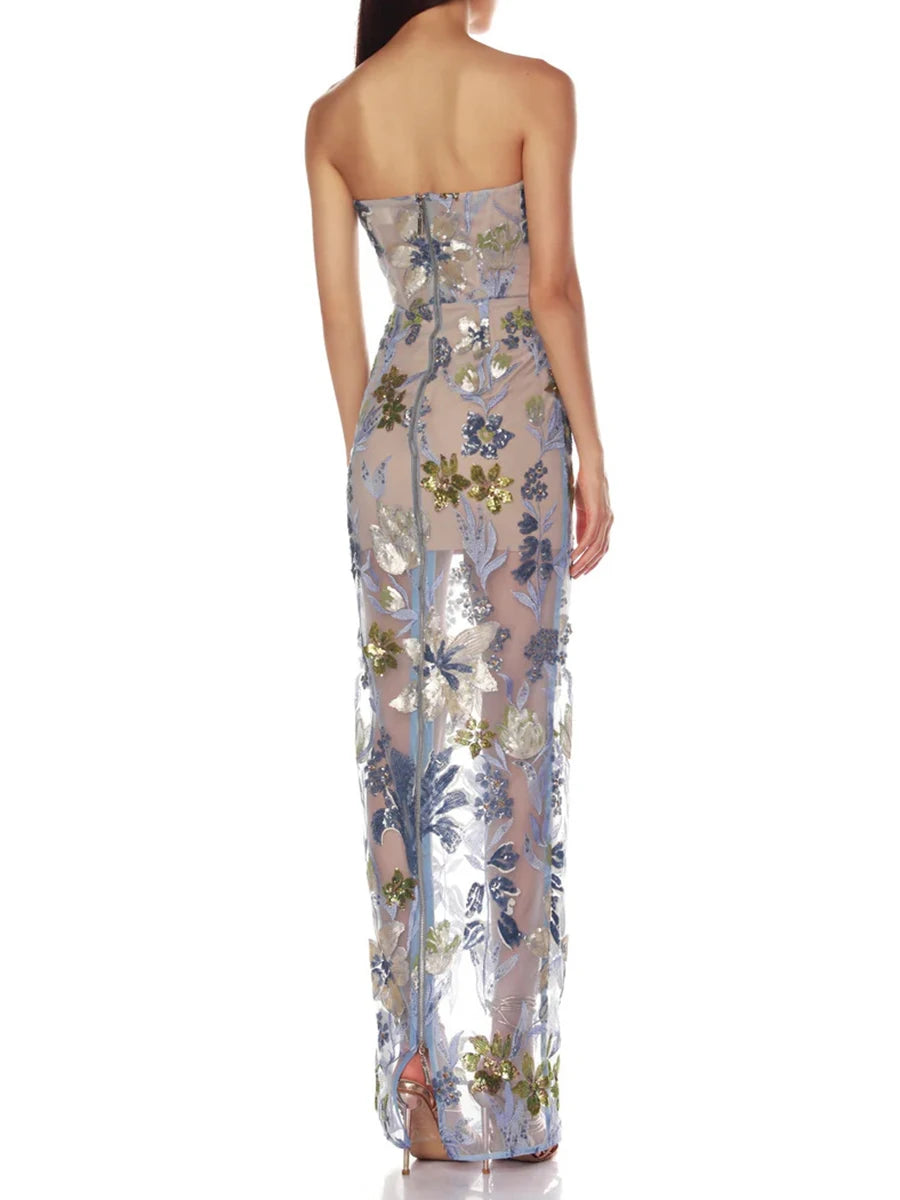 Woman wearing a strapless floral evening gown on a white background