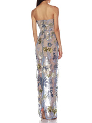 Woman wearing a strapless floral evening gown on a white background