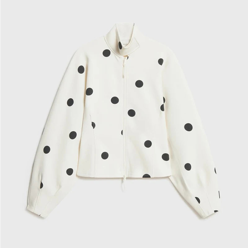 White jacket with black polka dots on a light gray background