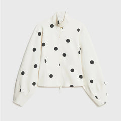 White jacket with black polka dots on a light gray background