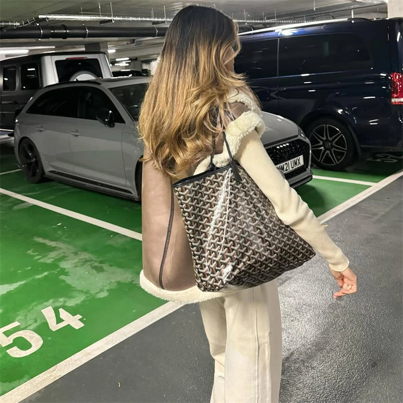 Woman walking in a parking garage with a patterned bag