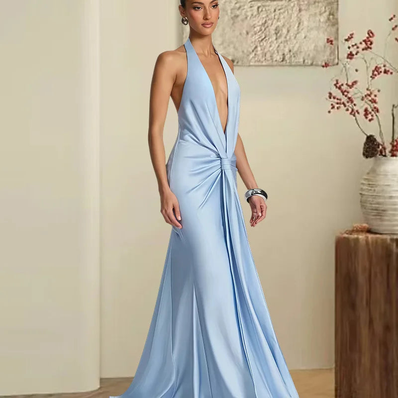 Woman wearing a light blue evening gown in an indoor setting.