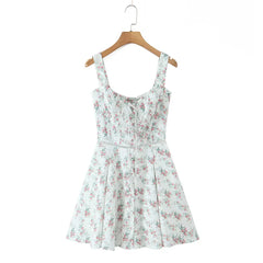 Floral dress on a wooden hanger against a white background