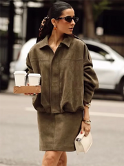 Woman in a brown dress holding coffee cups on a city street