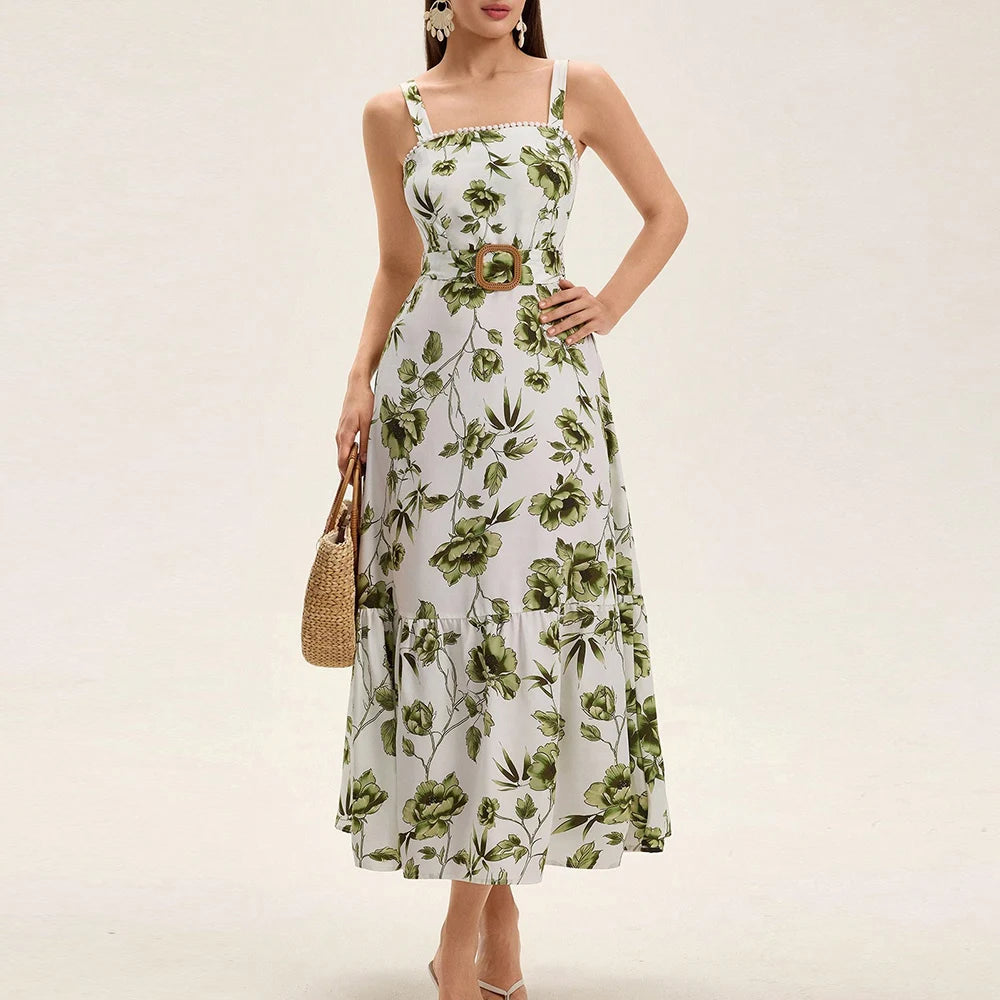 Woman wearing a floral dress with a belt on a plain background
