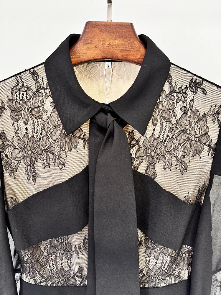 Close-up of black lace panel pleated maxi dress neckline
