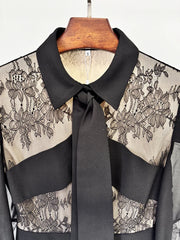 Close-up of black lace panel pleated maxi dress neckline