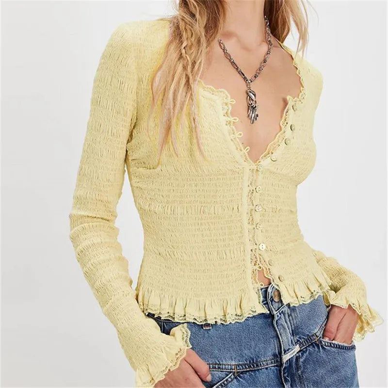 Yellow cardigan worn by a person on a plain background