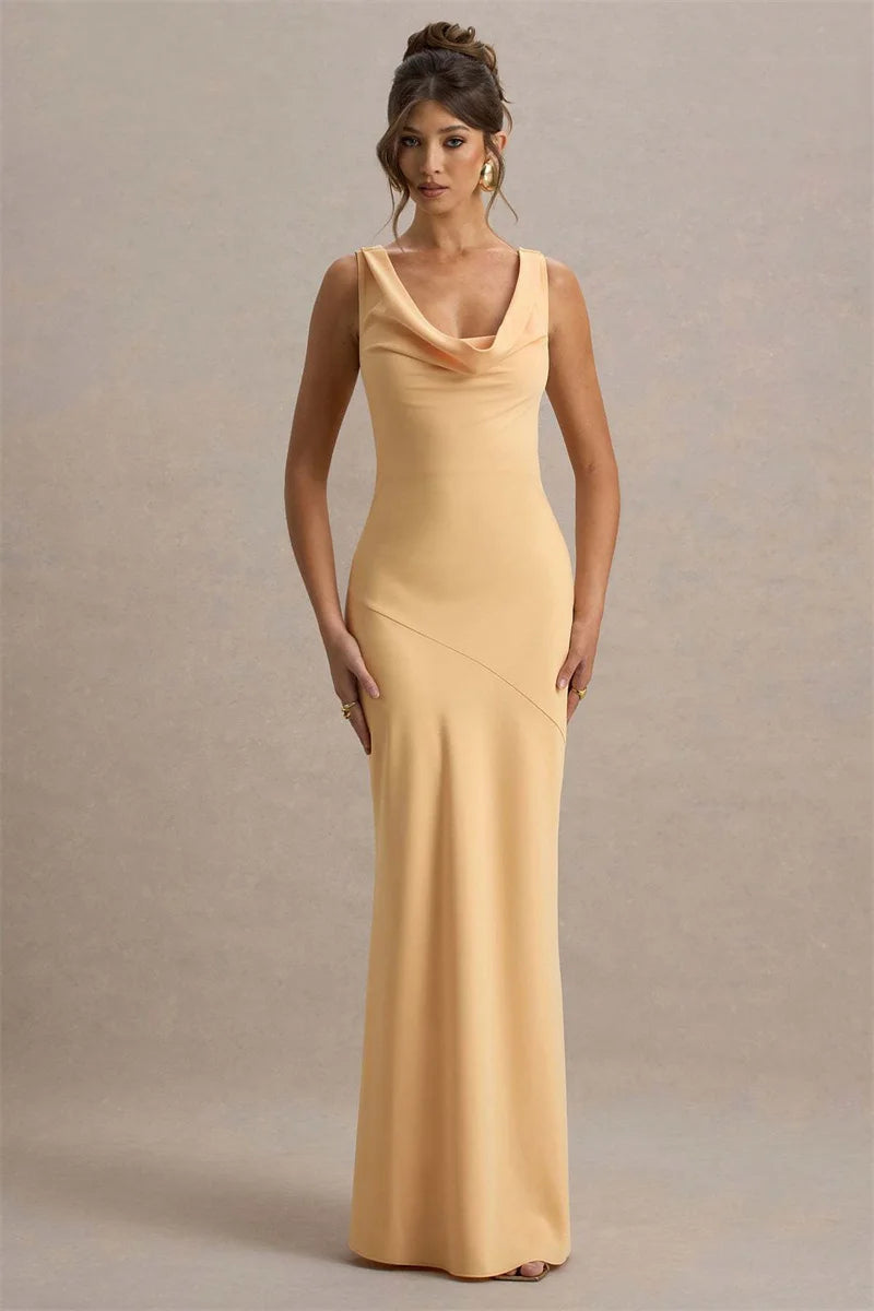 Woman wearing a long beige dress against a neutral background