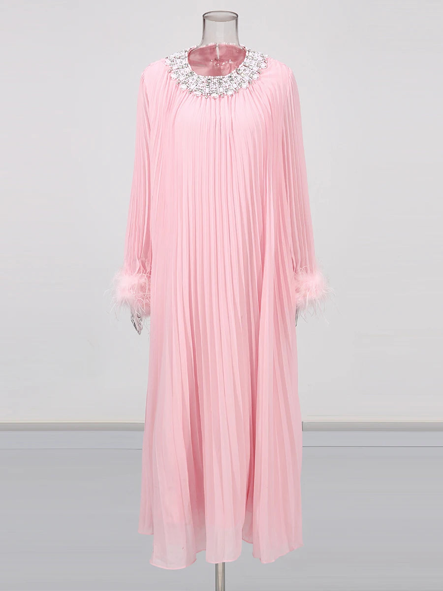 Pink pleated dress with a decorative neckline on a mannequin against a white background