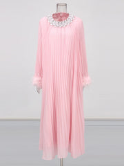 Pink pleated dress with a decorative neckline on a mannequin against a white background