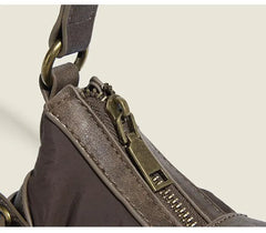 Close-up of a brown leather bag with a zipper on a beige background