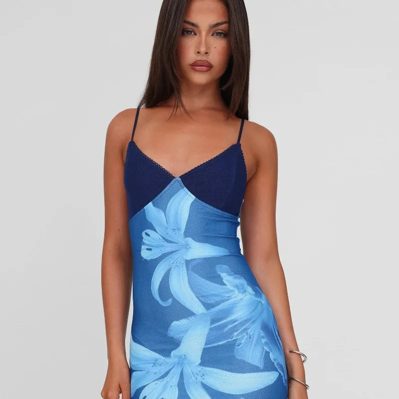 Woman wearing a blue floral dress on a plain background