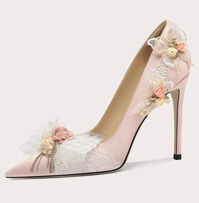 High-heeled shoe with floral design on a light gray background