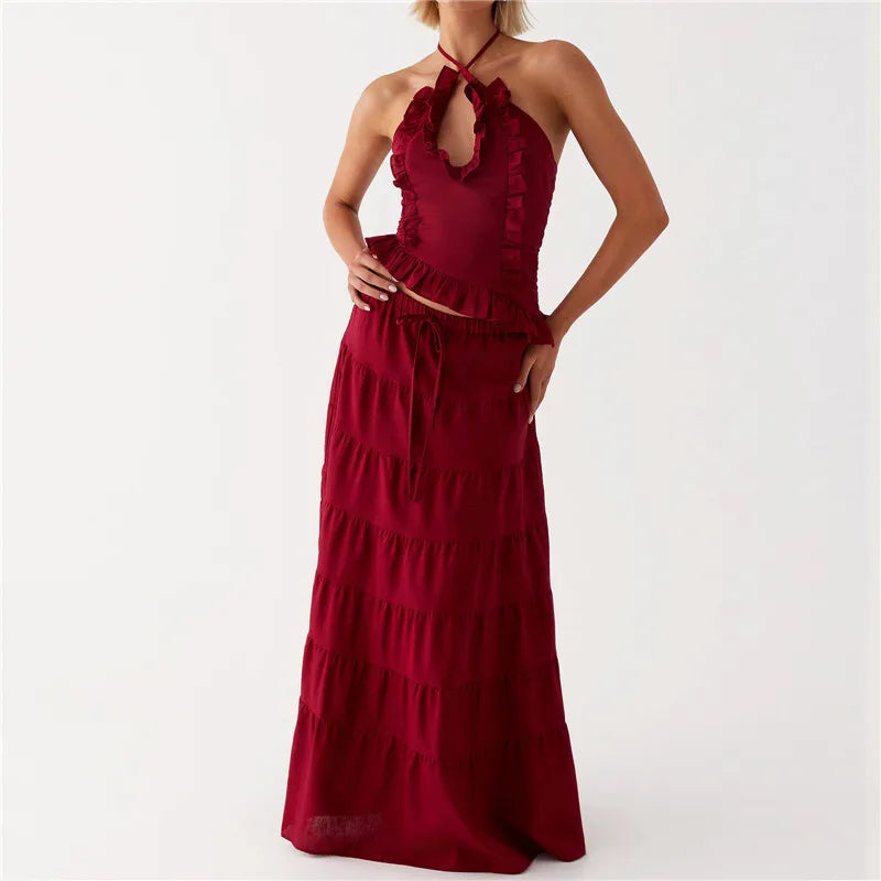 Red halter neck dress with ruffled details on a white background