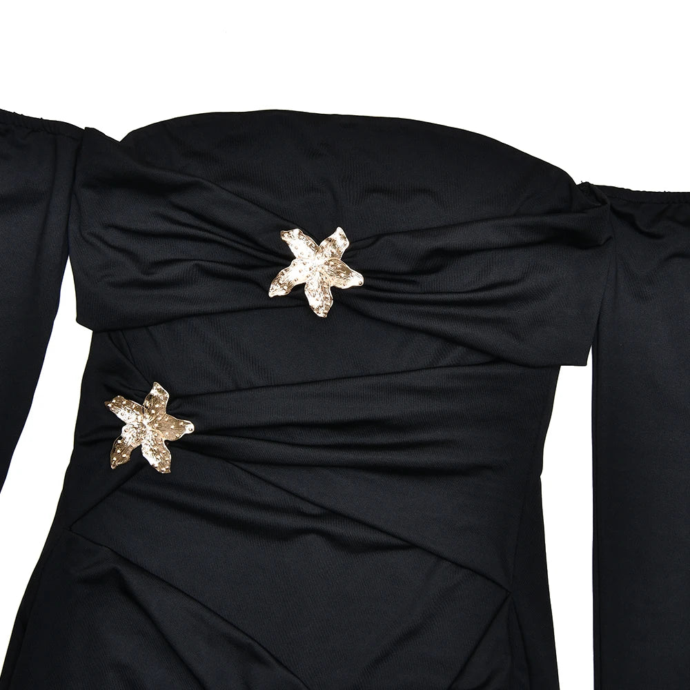 Black dress with star-shaped embellishments on a white background