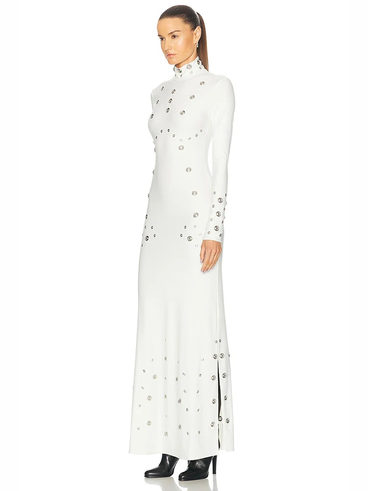 Woman wearing a long white dress with floral embellishments