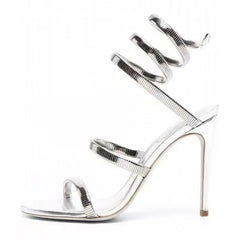 Silver high-heeled sandal with thin straps on a white background