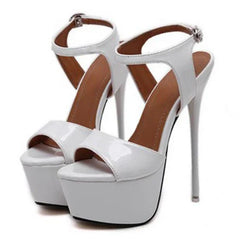 White high-heeled platform sandals with brown straps on a white background
