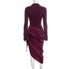 Maroon dress with long sleeves and draped design on a white background