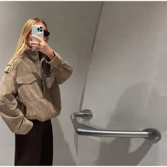 Stand collar suede bomber jacket on a person in profile