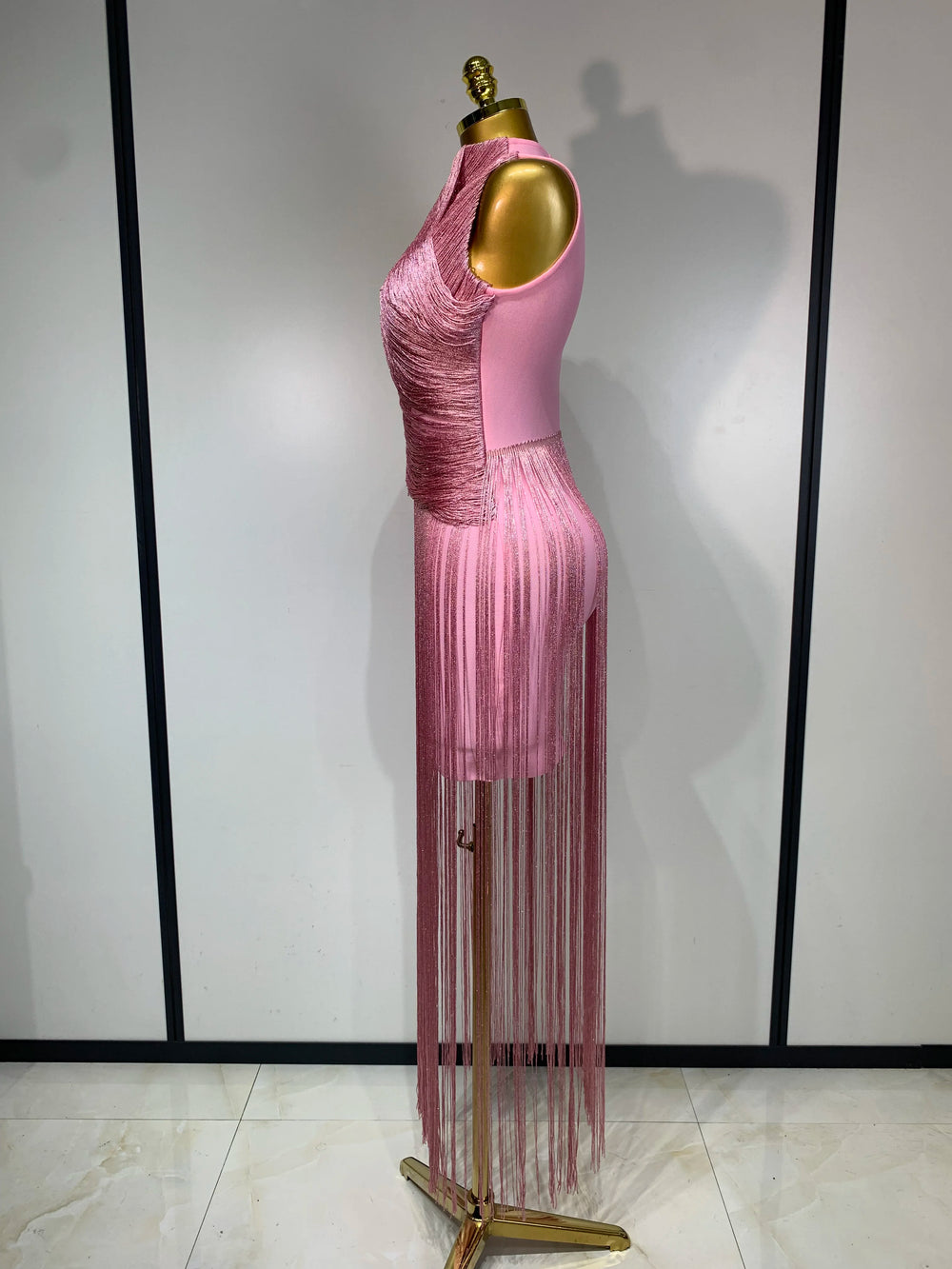 Side view of pink fringe turtleneck dress with detail