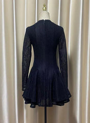 Navy blue dress on a mannequin against a beige curtain background
