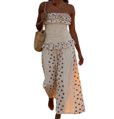 Woman wearing a polka dot dress with a white background
