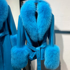 Blue coat with fur trim on a chair against a neutral background