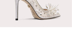 Sparkly high-heeled shoe with decorative elements on a white background