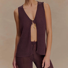 Brown knitted vest with open back on a neutral background