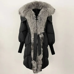 Black puffer coat with gray fur hood and trim on a light beige background