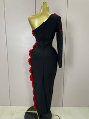 Black one-shoulder dress with red floral details on a mannequin against a white wall.