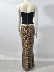 Mannequin wearing a black top and leopard print skirt against a white background