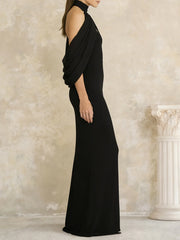 Black evening gown with draped design on a neutral background