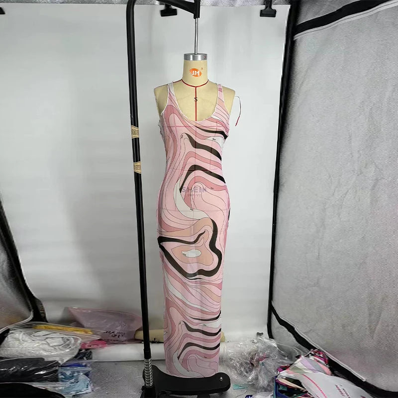 Mannequin wearing a pink and black patterned dress in a studio setting