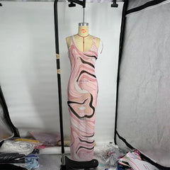 Mannequin wearing a pink and black patterned dress in a studio setting