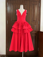 Red dress on a mannequin against a wooden door background