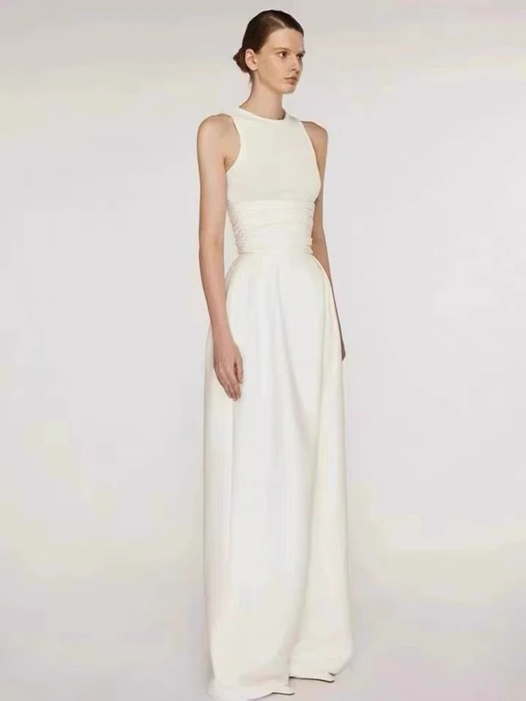 Woman wearing a white evening gown against a plain background