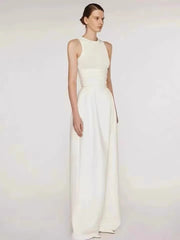 Woman wearing a white evening gown against a plain background