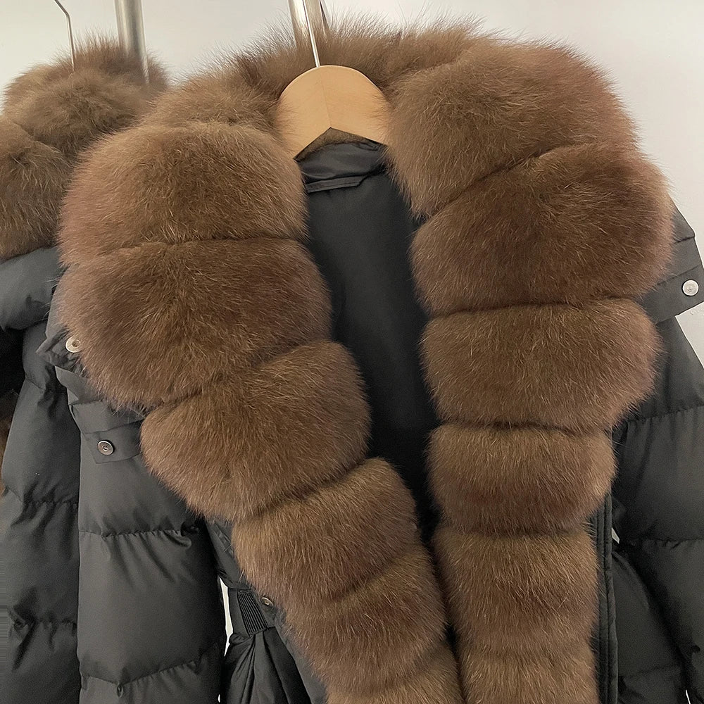 Black puffer jacket with brown fur trim on a hanger