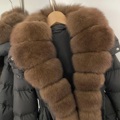 Black puffer jacket with brown fur trim on a hanger