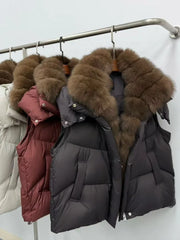 Black puffer jacket with brown fur hood on a rack against a white background