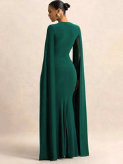 Green evening gown with cape on a beige background